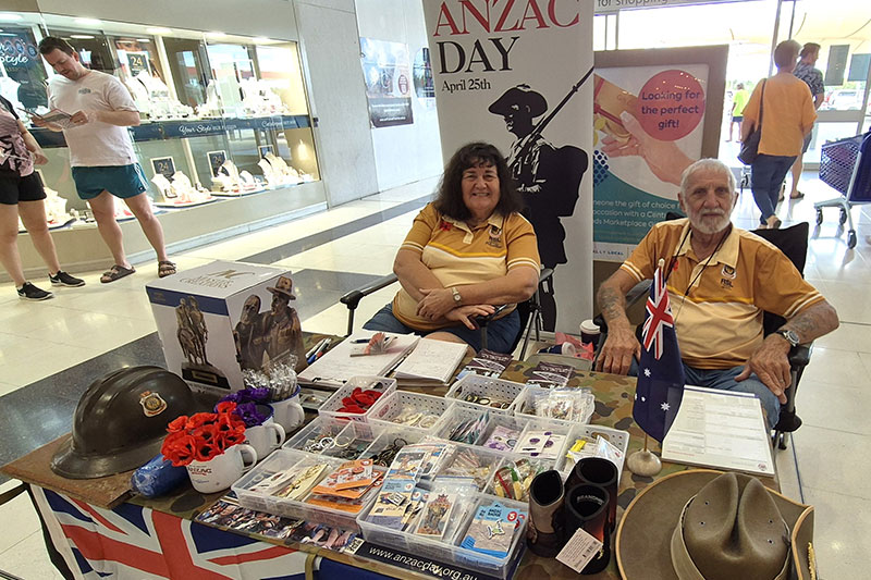 Image: Emerald Today - Noel and Margaret Mallyon selling badges and pins in the lead up to ANZAC Day