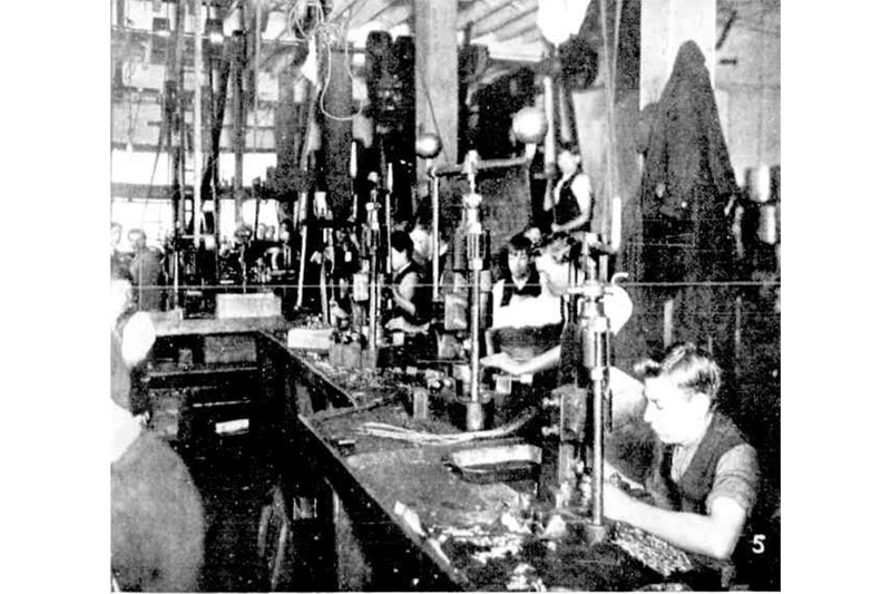 Employees of Stokes and Sons hand-stamping badges and buttons at the company’s Melbourne premises during the World War I (The Australasian, 18 September 1915, 25)