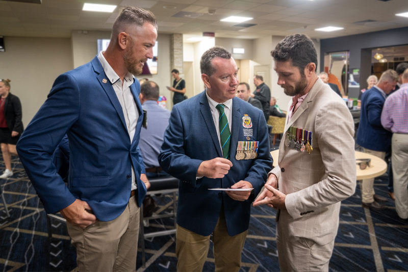 Veterans looking at a postcard