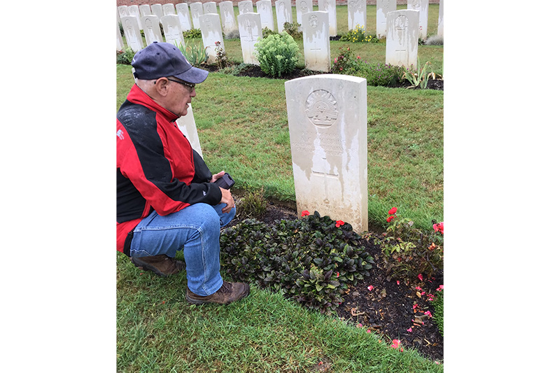Kalbar RSL Sub Branch member Stephen Pace lays poppies at the headstone of Kalbar man Corporal Andrew Curry McBride.