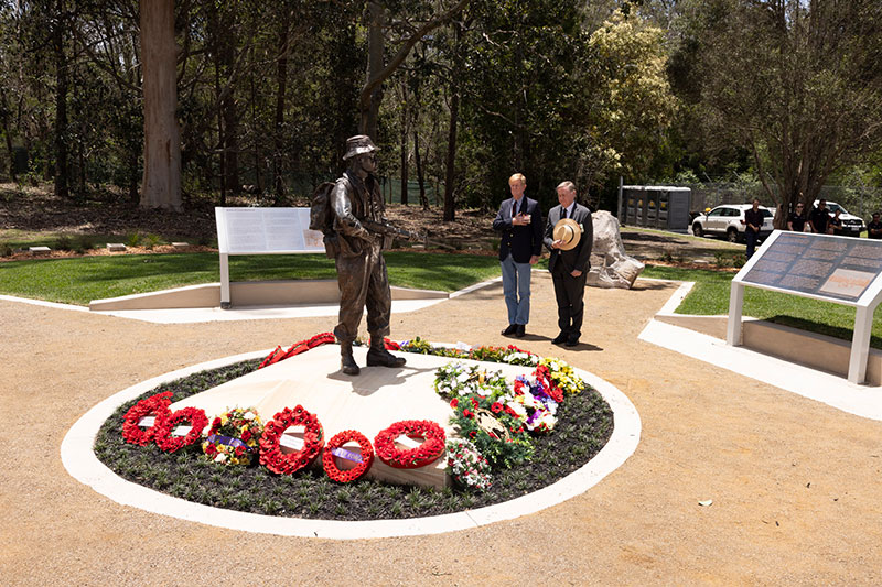 Two gentlemen taking a moment of silence at the Canungra Vietnam War Memorial. 