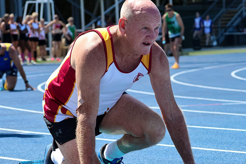 Veteran Bruce Bodsworth lined up at the start line of a running race. 