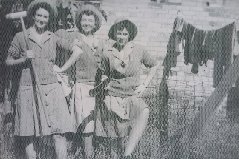 Black and White image of Elsie Dalzell standing with friends