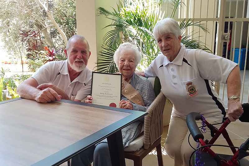 WW II veteran Betty Robinson of Tweed Heads and Coolangatta RSL Sub Branch, receiving her 100th birthday certificate from Sub Branch Director Geoff Partridge and his wife Jan Partridge