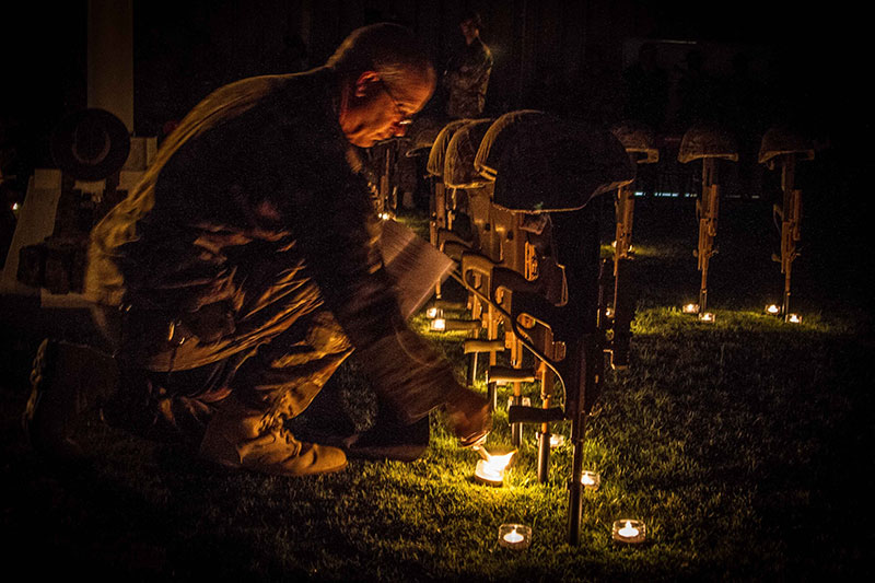 Chaplain Geoffrey Traill lights a candle as part of an ANZAC Day service held for Australian service personnel at Kandahar Airfield in Afghanistan in 2014. Photo by Sgt Clay Beyersdorfer
