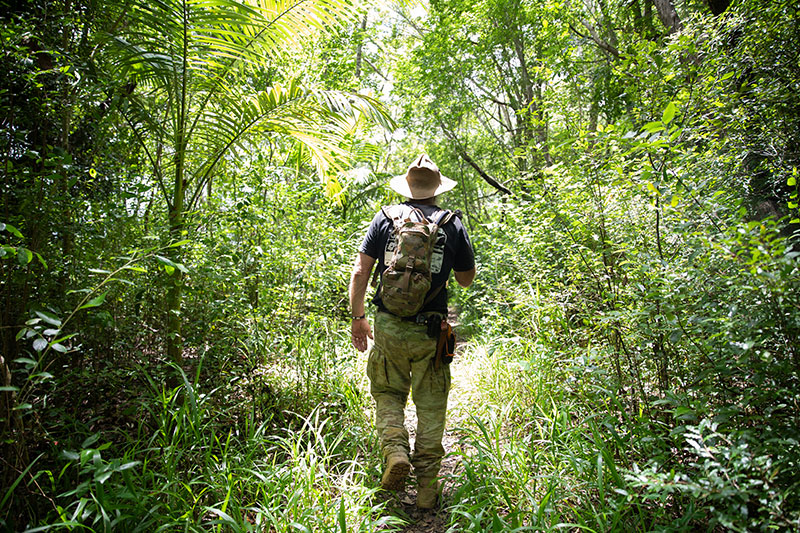 Rick Peterson walking through the bush. 