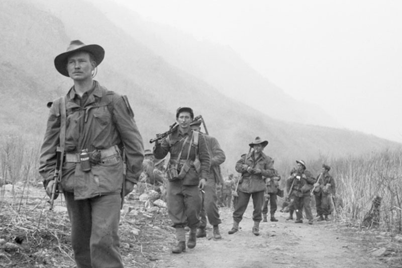 Image: Australian War Memorial | Members of C Company 3RAR, lead by CPL Len Wright (left), move forward from Hill 614 to attack Hill 587.