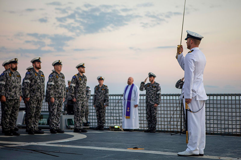 Members of the Royal Australian Navy commemorating ANZAC Day onboard HMAS Ballarat