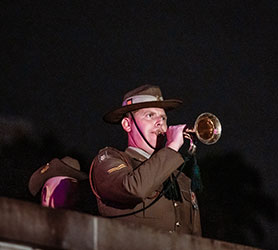 Australian solider plays a bugle on ANZAC Day