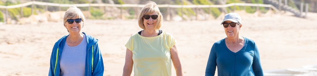Three women walking on the beach